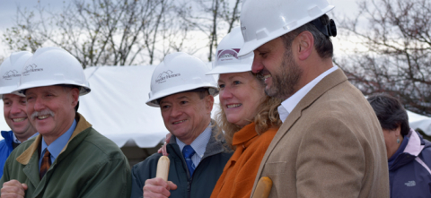 dave adams poses in hardhat at groundbreaking